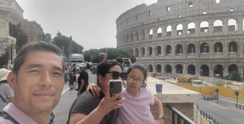 A family photo beside the Colosseum in Rome