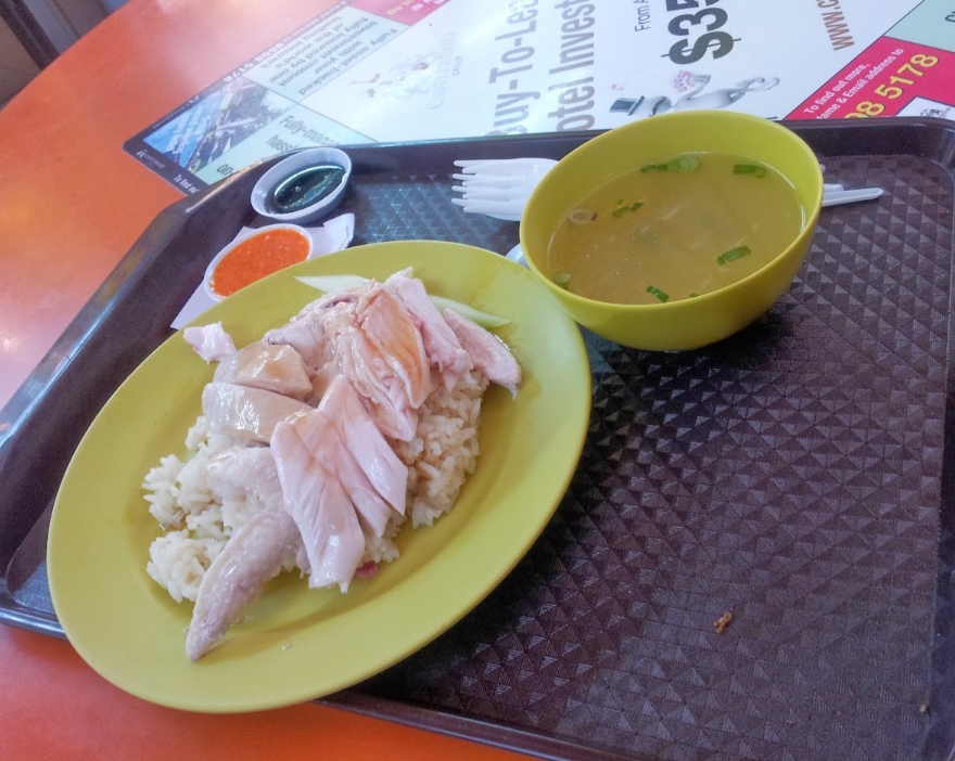 Chicken rice with soup and dipping sauces in Singapore